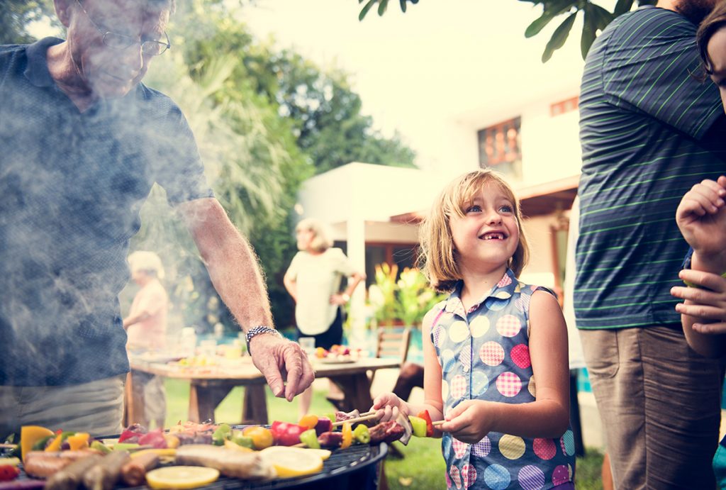 a little blonde girl saying good-bye to Big Fish Bay at a backyard cookout