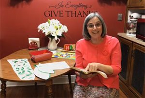 Faith Hixson pointing in her Bible as she teaches from home during coronavirus