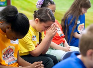 Junior or youth girls praying in VBS