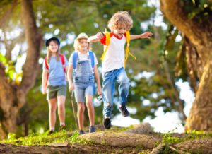 Kids walking outdoors for kinesthetic learning style for sharing the gospel VBS 2024 Stompers & Chompers